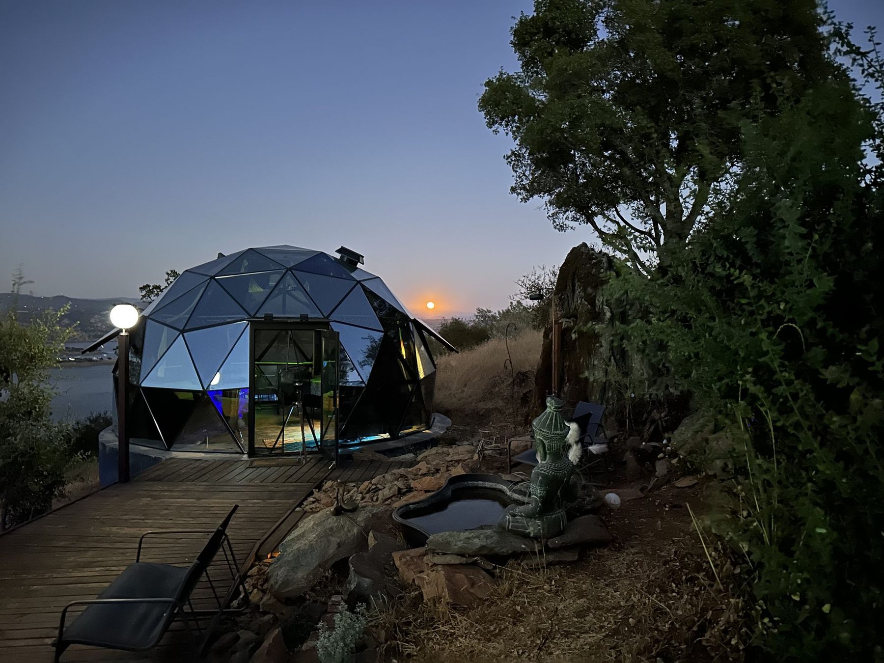 A full moon rising over the glass dome